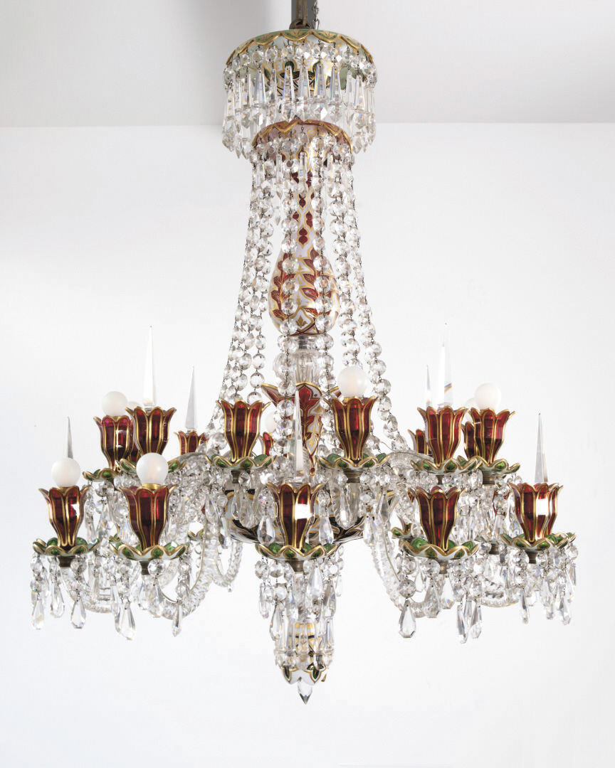 Baccarat glassworks, last quarter of 19th century, cut crystal chandelier with twenty-four arms, ruby-red tinted tulips and columns with bulges, white and almond green tinted drip-pans, the faceted arms hung with numerous drops, around 110 x 100 cm/43.3 x 39.4 in. Result: €51,520