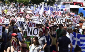 People hold placards reading "No" during a demonstration in support of Greece, in Madrid on July 5, 2015. (Agence France-Presse)