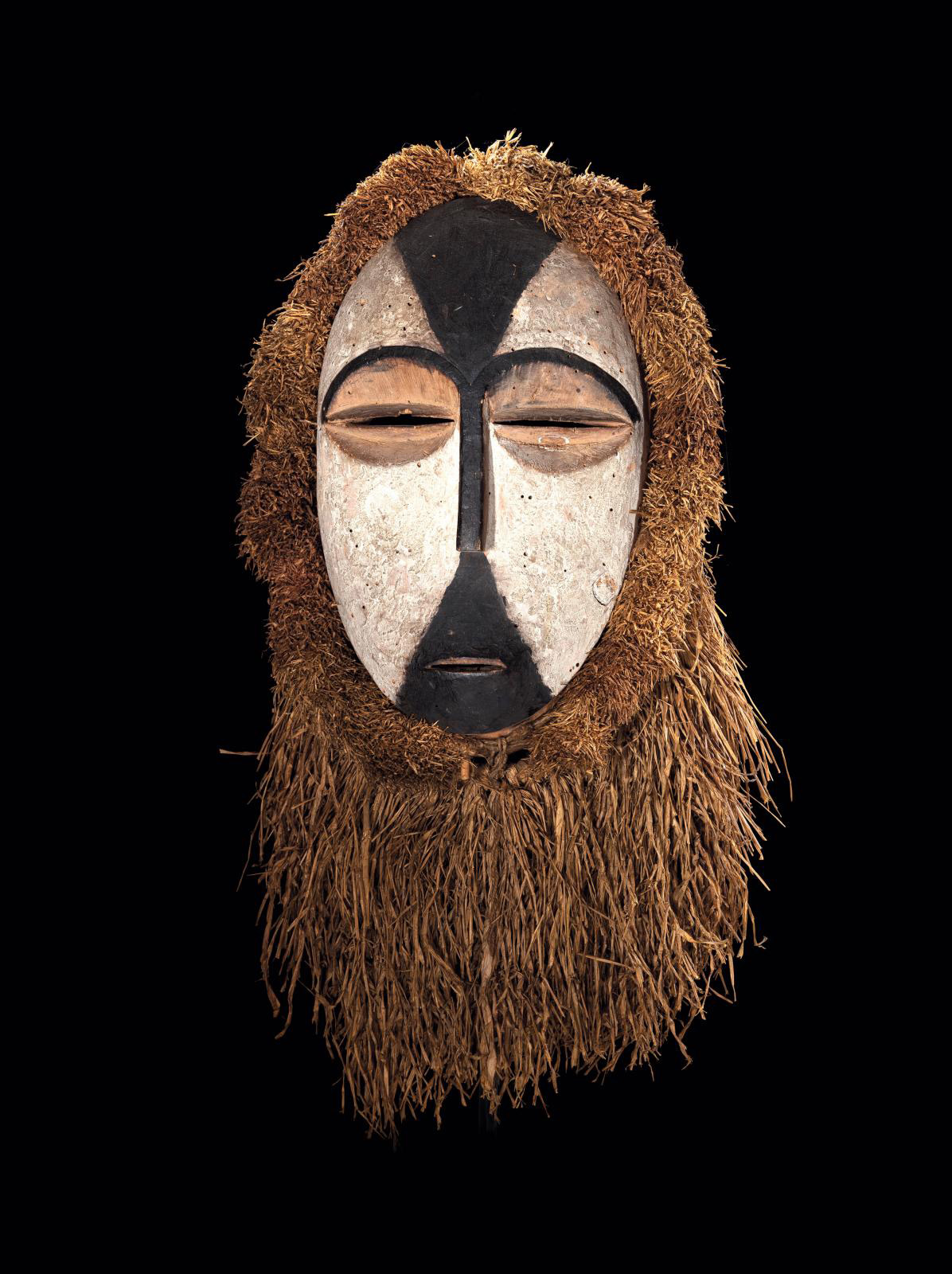 Gabon, 19th century, Galoa People, Okukwe Mask, wood, black and white pigments, raffia, h. 27 cm/10.62 in. Galerie Patrik Fröhlich. Courtesy Galerie Patrik Fröhlich