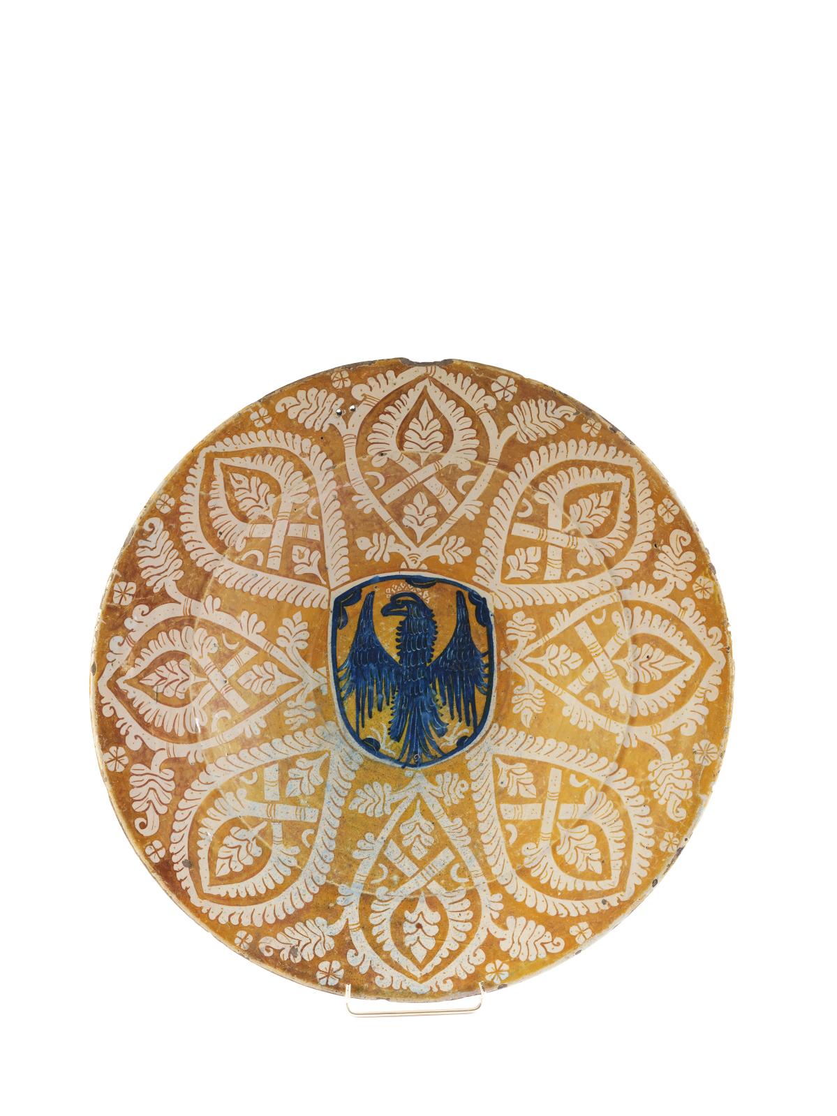Large round earthenware dish decorated with a blue coat of arms in the center, stylized foliage on a lustrous ochre ground, c. 1450-1475, diam. 46 cm/18.1 in. Saint-Cloud, October 6, 2019. Le Floc'h auction house. Mr. Froissart. Result: €43,750. Large round earthenware dish decorated with a blue coat of arms in the center, stylized foliage on a lustrous ochre ground, c. 1450-1475, diam. 46 cm/18.1 in. Saint-Cloud, October 6, 2019. Le Floc'h auction house. Mr. Froissart. Result: €43,750.