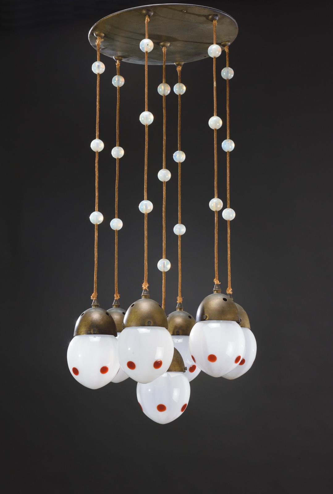 Attributed to Koloman Moser (1868–1918) and the Bakalowits & Söhne factory, hammered brass seven-light hanging lamp with cords, opalescent and frosted glass, h. 100 cm/39.37 in, diam. 35 cm/13.78 in. Estimate: €4,000/6,000 Attributed to Koloman Moser (1868–1918) and the Bakalowits & Söhne factory, hammered brass seven-light hanging lamp with cords, opalescent and frosted glass, h. 100 cm/39.37 in, diam. 35 cm/13.78 in. Estimate: €4,000/6,000